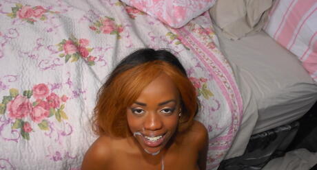 Sultry black Honey Droppz blowing huge cock and enjoys a cum blast on her face 