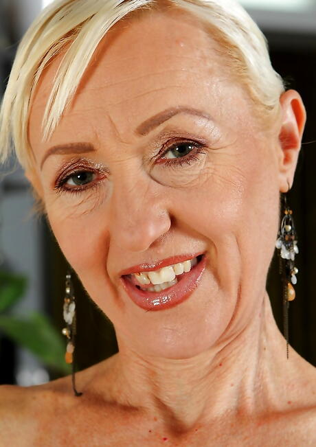 Excellent blonde mature Tina shows her ass in fancy skirt and spreads her legs 